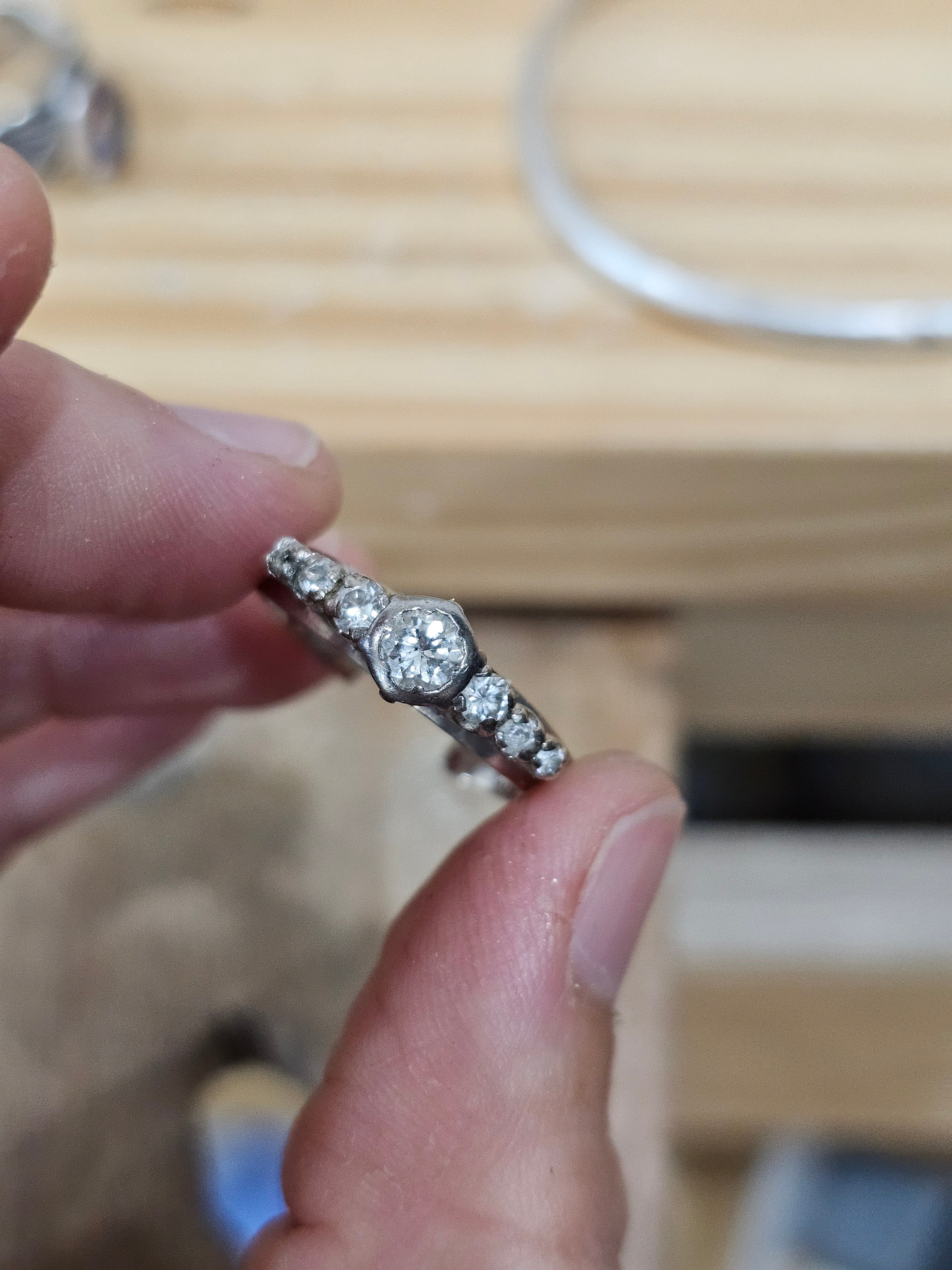 Diamond ring held between fingers before recycling