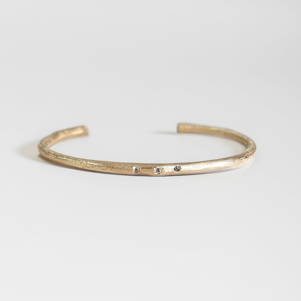 Gold bracelet with three diamond stones, handmade cuff by zoe alexandria jewellery