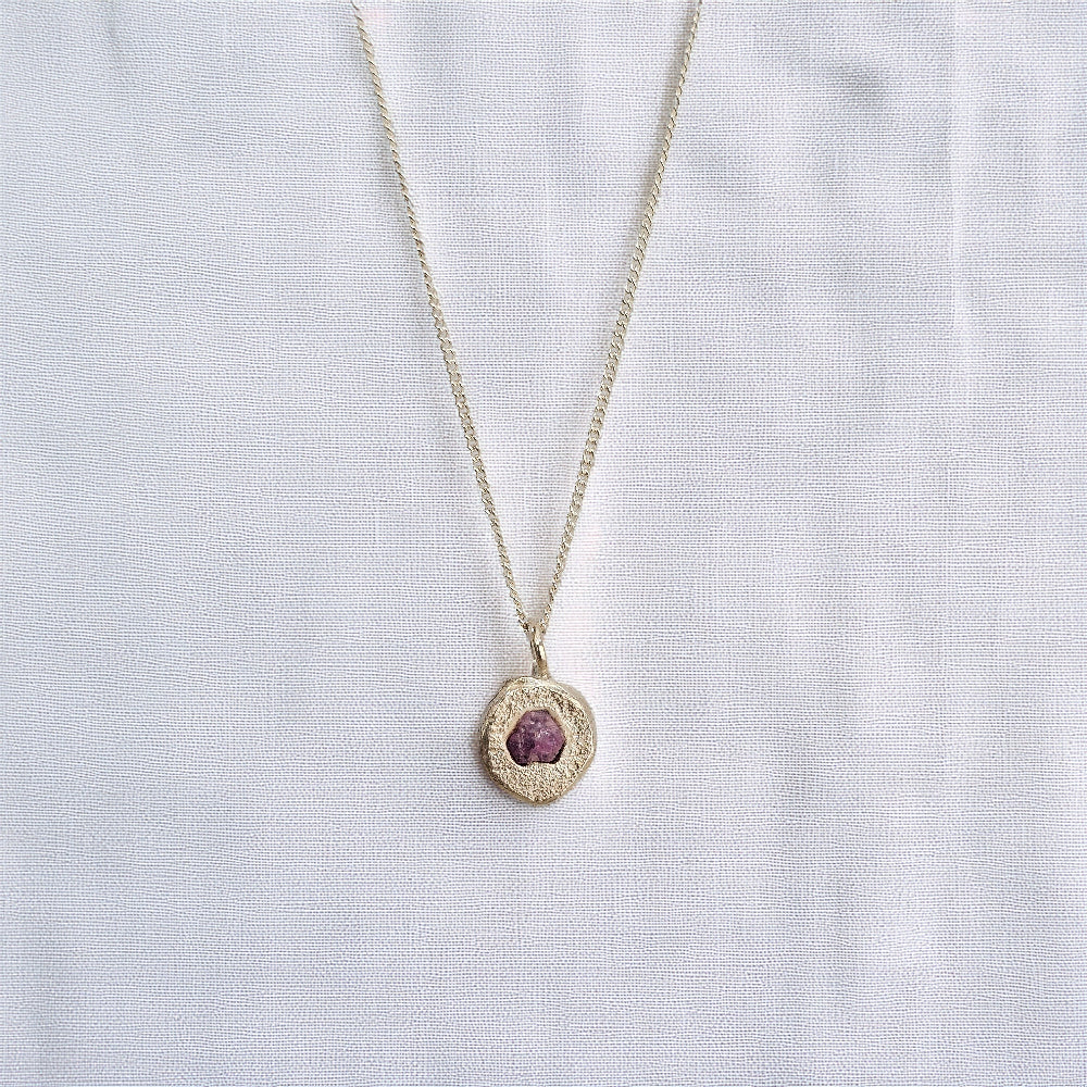 cast in place rough pink sapphire pendant by zoe alexandria jewellery recycled silver